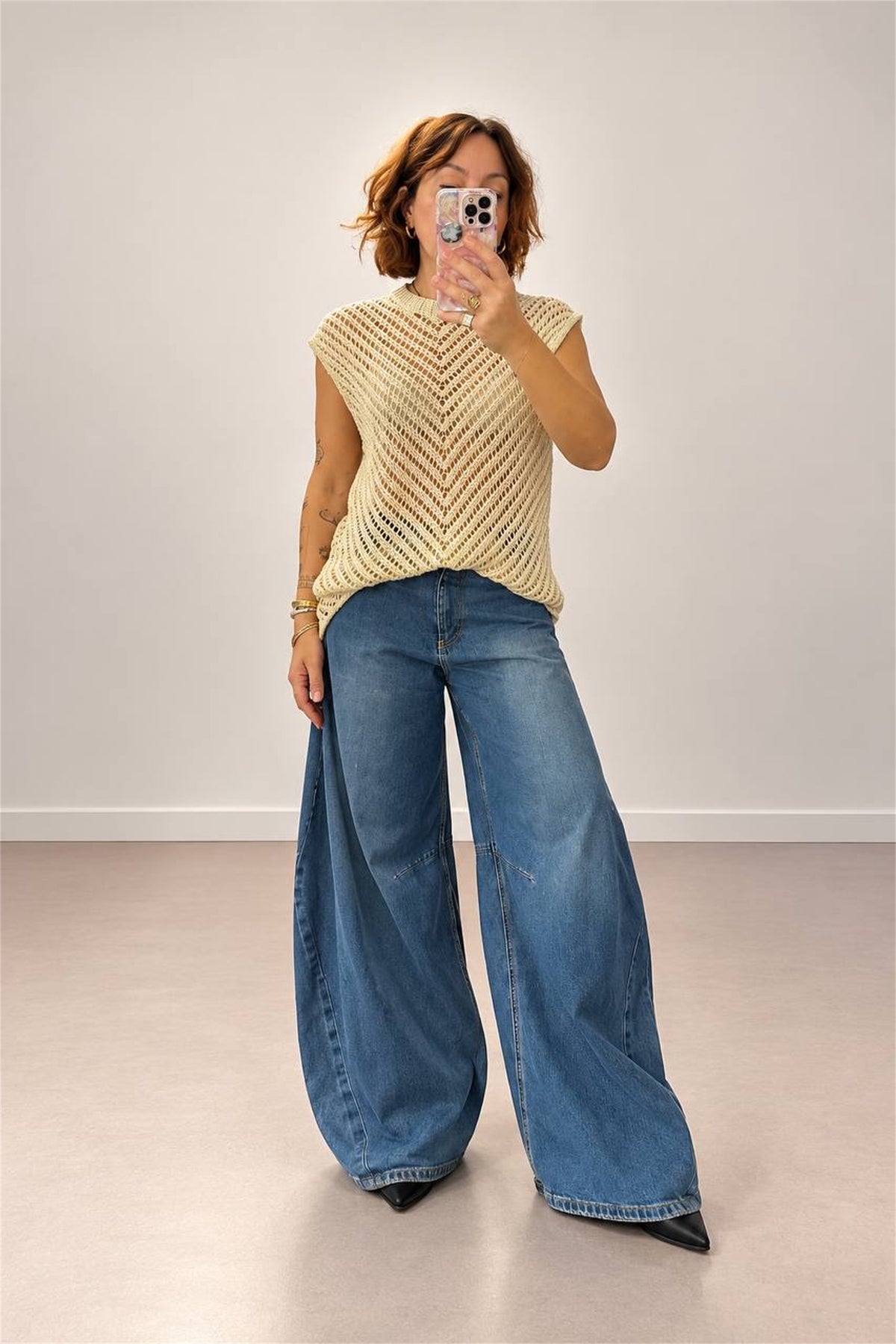 Maglia beige traforata con jeans ampi, vista frontale indossata